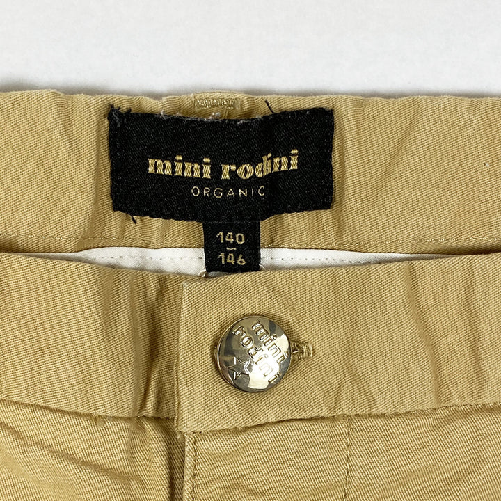 Mini Rodini beigefarbene Shorts mit M-Print 140-146